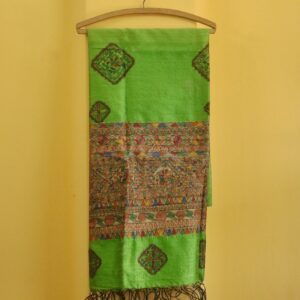 The Emerald Heritage Dupatta brings to life classic Madhubani artistry on a radiant green silk base. Featuring intricate hand-painted motifs framed in geometric borders, this piece is both a celebration of culture and a statement of style. Highlights: ● Lush green silk with handpainted Madhubani art ● Vibrant geometric and floral motifs in natural tones ● Elegant tassels for a graceful finish ● Handpainted to perfection by rural artisans Dimensions: ● Length: 97.5 inches ● Width: 35 inches Material: Blended Silk with Fabric Paint